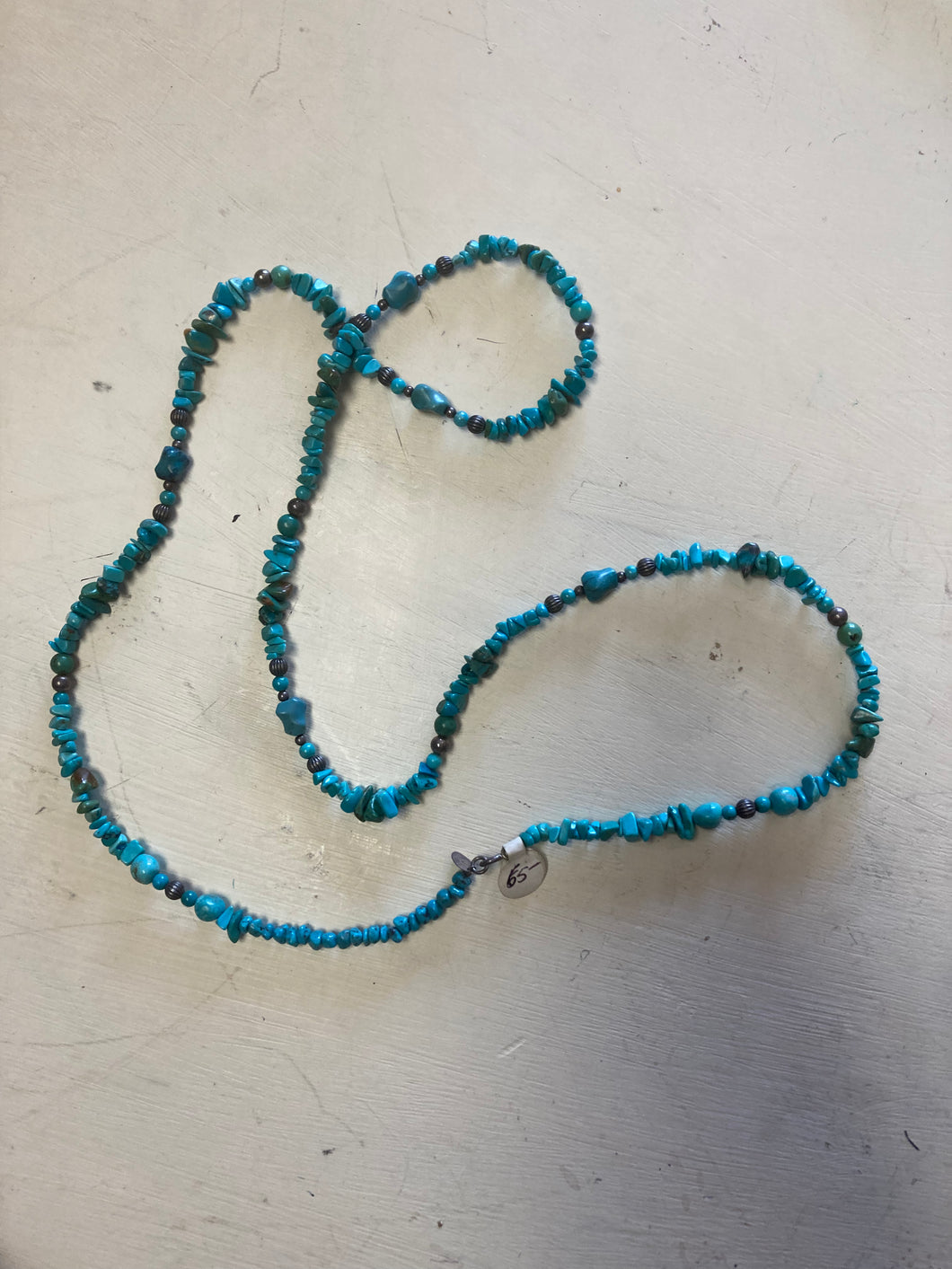 Turquoise necklace with interspersed silver ornaments
