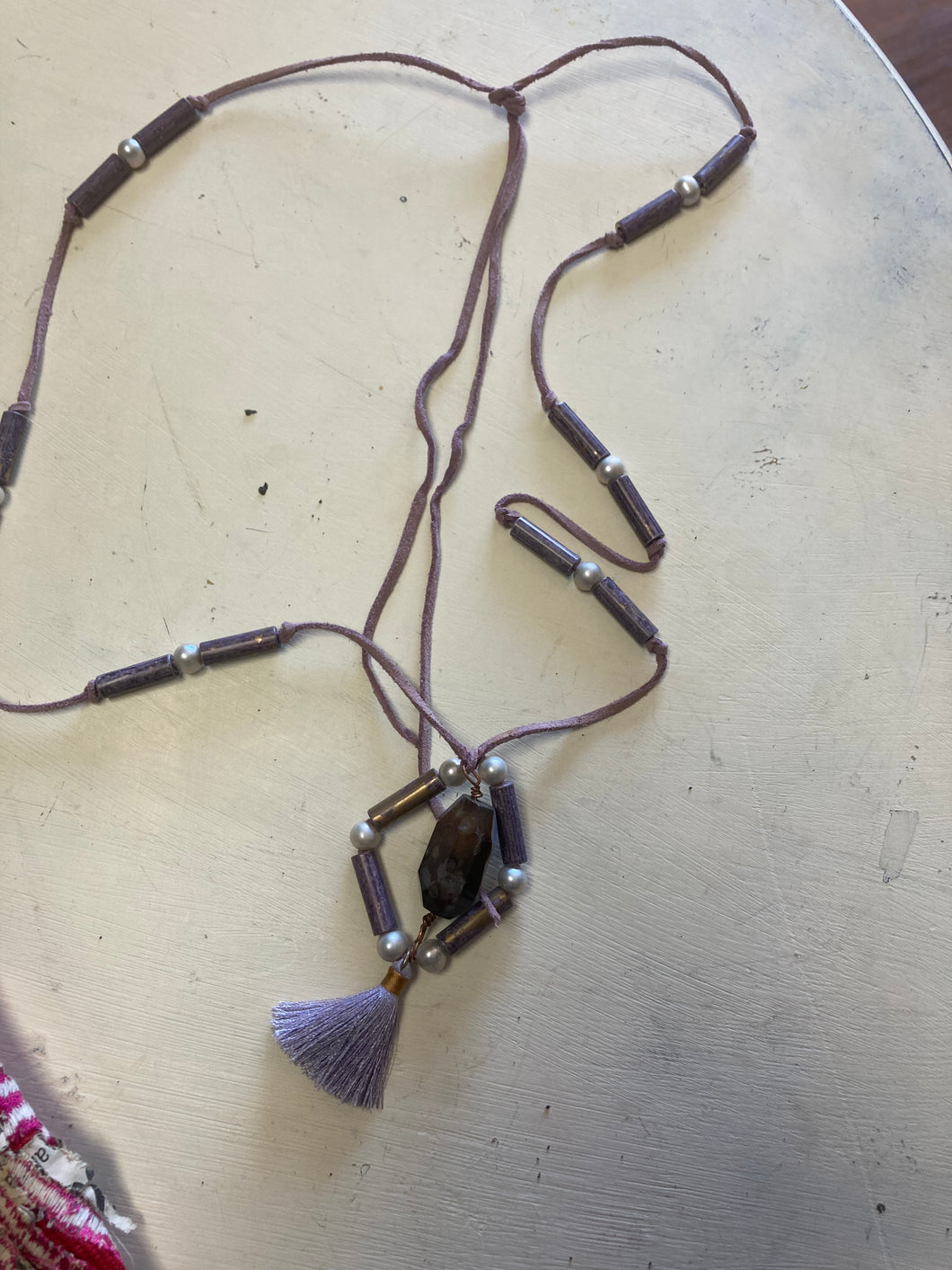 Plastic bead pendant necklace with purple tassel and pendant